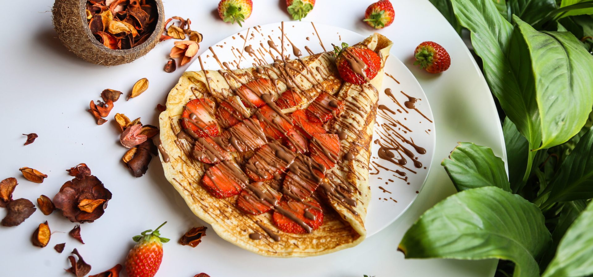 pancake topped with strawberry slices and chocolate top view