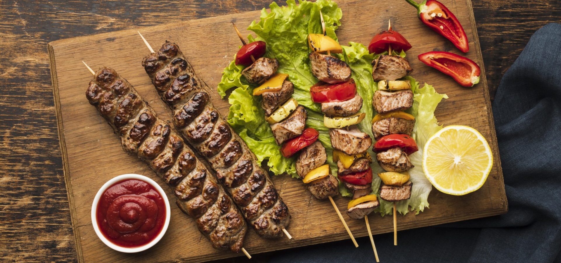 top-view-chopping-board-with-delicious-kebab-lemon